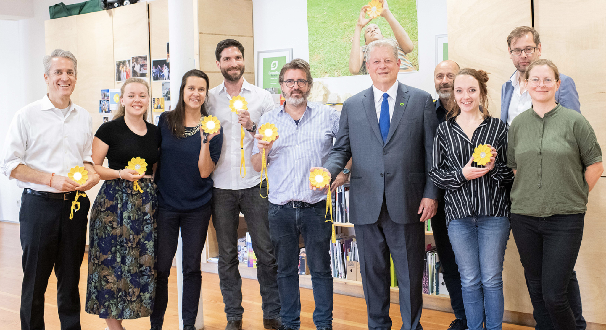 The Little Sun team holding Little Sun lamps
